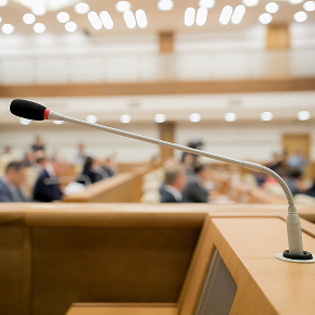 microphone in a court room with people in the background sitting down